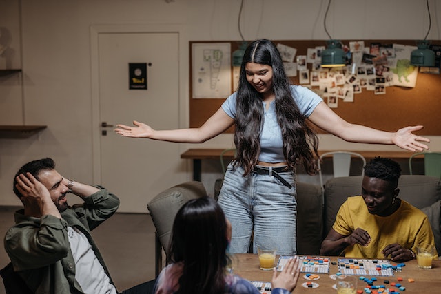 a group of friends playing games around a table