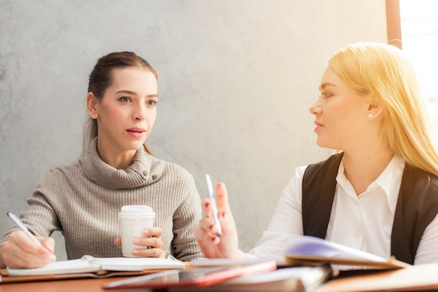 two people having a conversation at a table