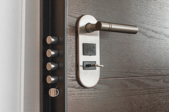 wooden door with four-prong dead-bolt locking system
