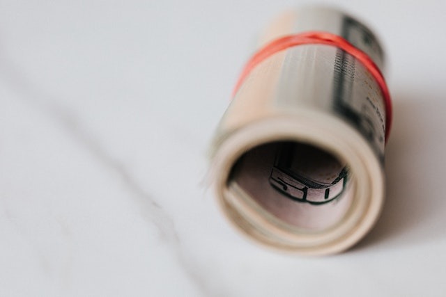 a roll of money sitting on a table