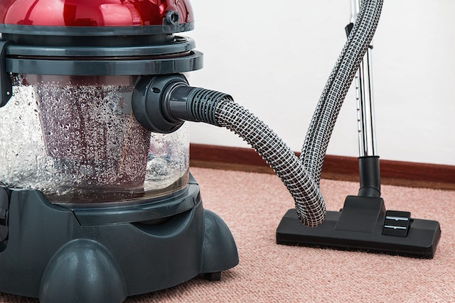 a steam cleaner vacuum sitting on a rug