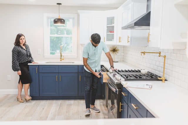 two people inspecting a kitchen