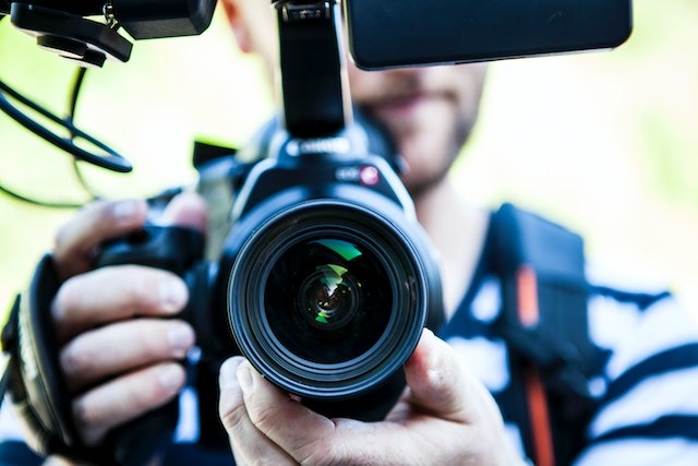 person holding a professional video camera