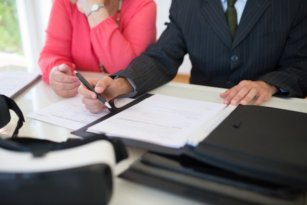 a property manager overseeing the signing of a lease agreement